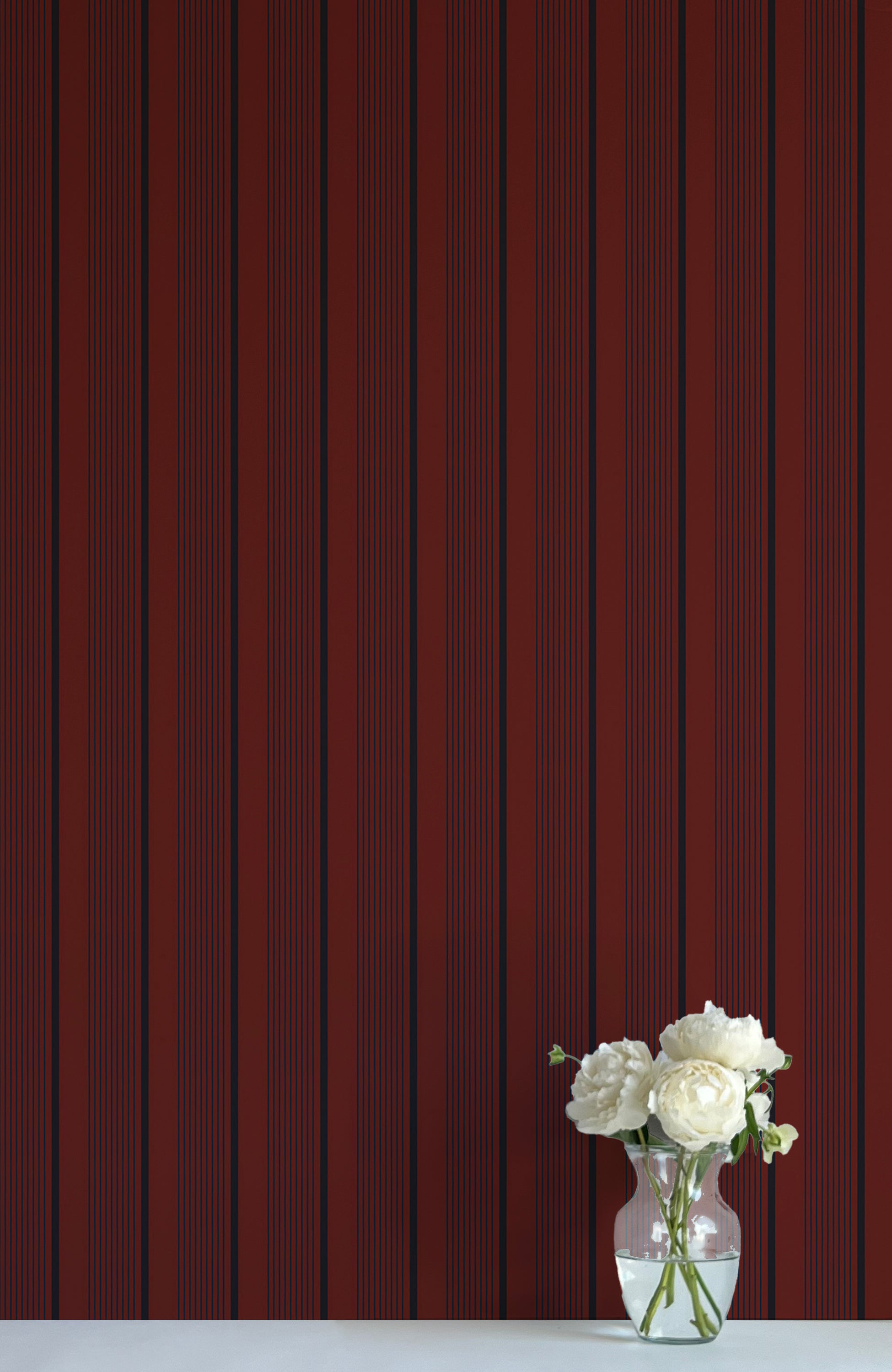 Vase with white flowers against a red striped background