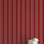 Striped red and blue wallpaper with a vase of flowers on a matching surface.