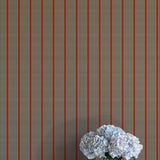 Striped wallpaper with a vase of flowers on a white surface