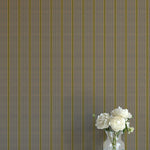Striped wallpaper with a vase of flowers on a plain surface