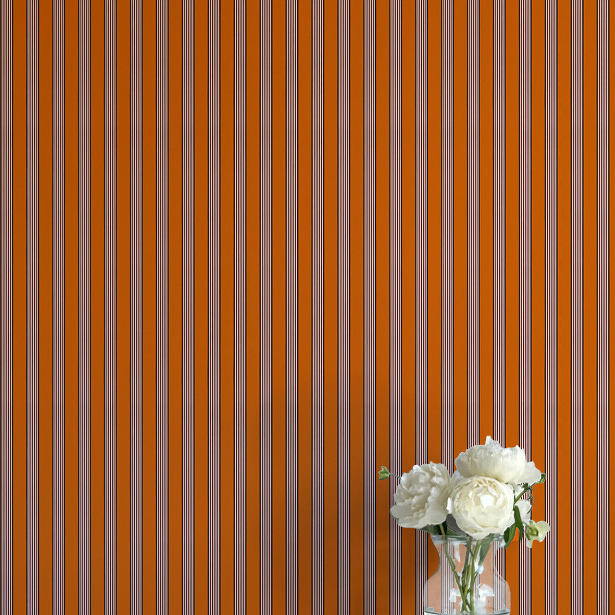 Striped wallpaper with a vase of flowers on a flat surface