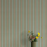 Striped wallpaper with a vase of flowers in the foreground