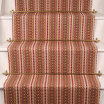 Striped flatweave runner in pink red green on white staircase