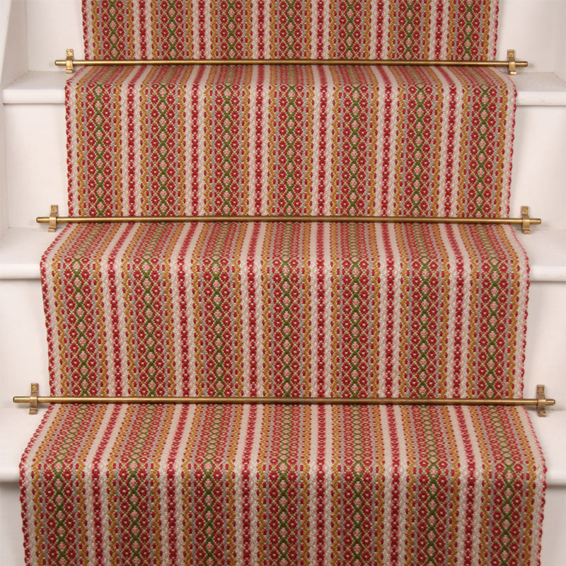 Striped flatweave runner in pink red green on white staircase