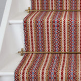 Striped flatweave runner in red pink tan on white staircase