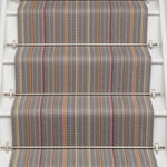 Striped flatweave runner in grey pink orange on white staircase