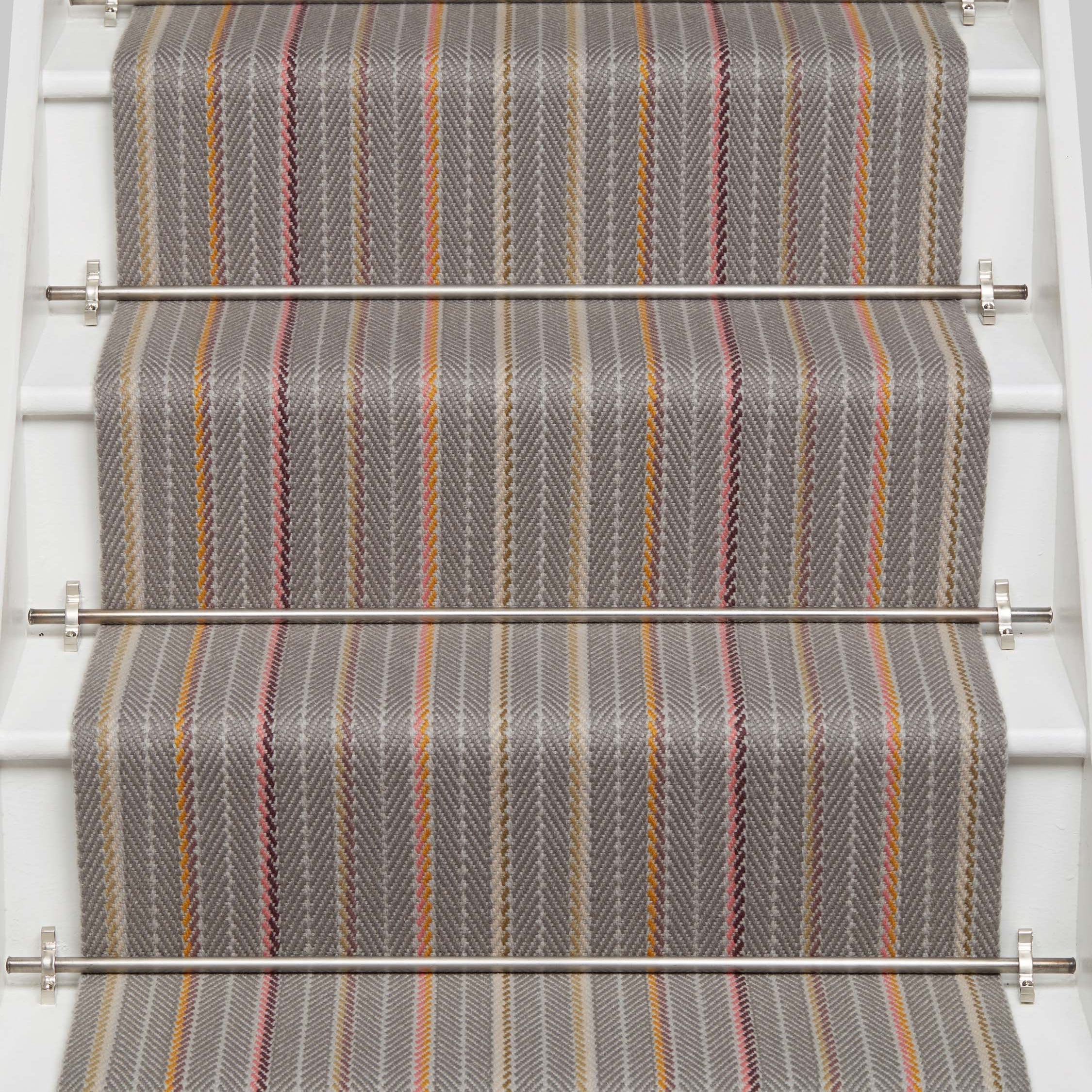 Striped flatweave runner in grey pink orange on white staircase