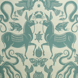 Teal animal and nature-themed pattern on a beige background