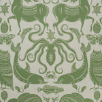 Patterned wallpaper with green animals and sea creatures on a beige background