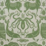 Patterned wallpaper with green animals and sea creatures on a beige background