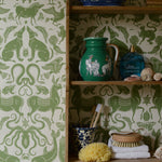 Shelves with decorative items against a green and white patterned wallpaper