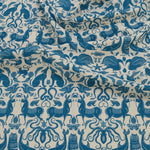 Draped patterned fabric with animals and sea creatures in blue on a white background