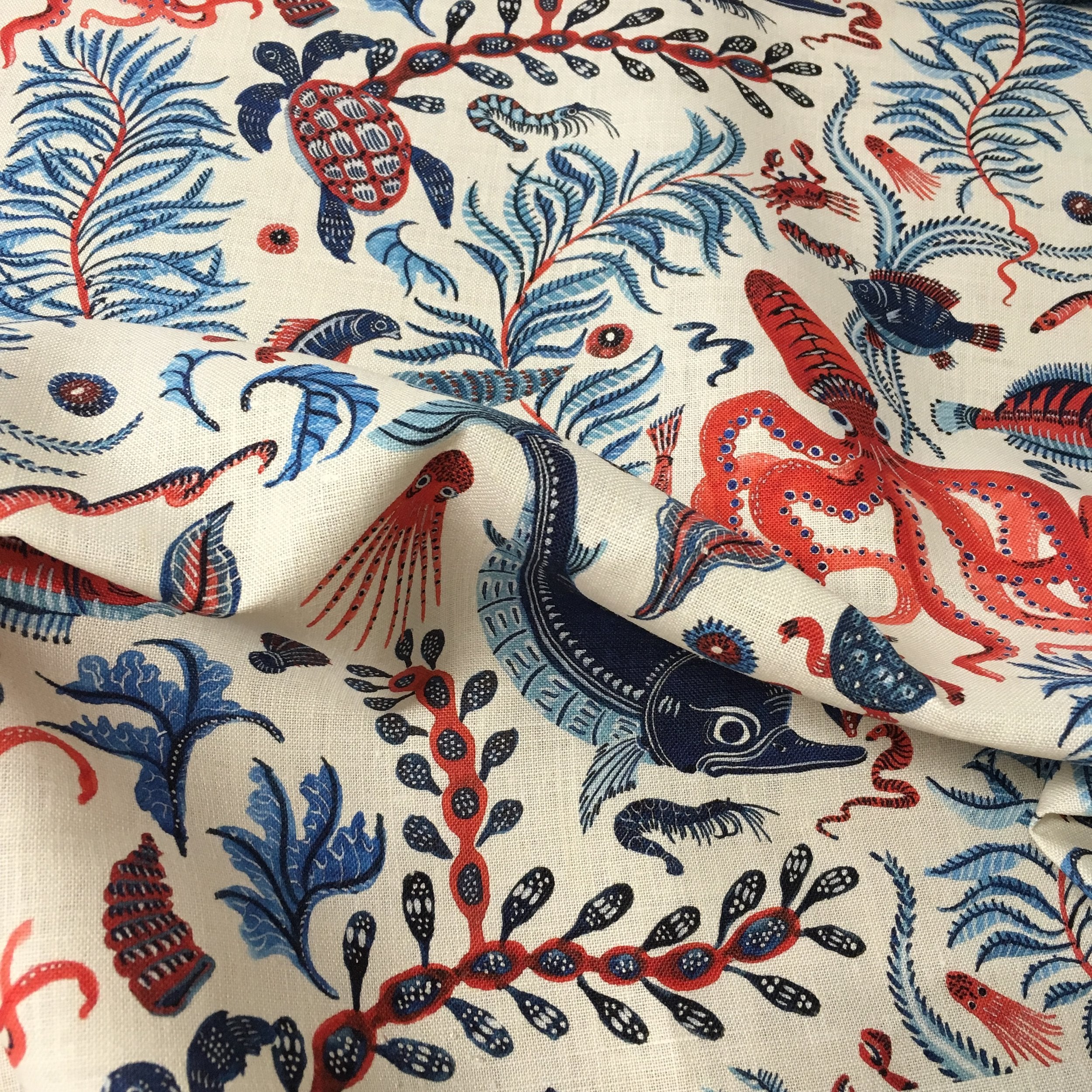Fabric with red, blue, and  pink marine-themed pattern