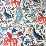 Ocean-themed fabric pattern with red, blue, and black sea creatures on a white background.