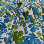 Fabric with blue and green leaf pattern on a white background