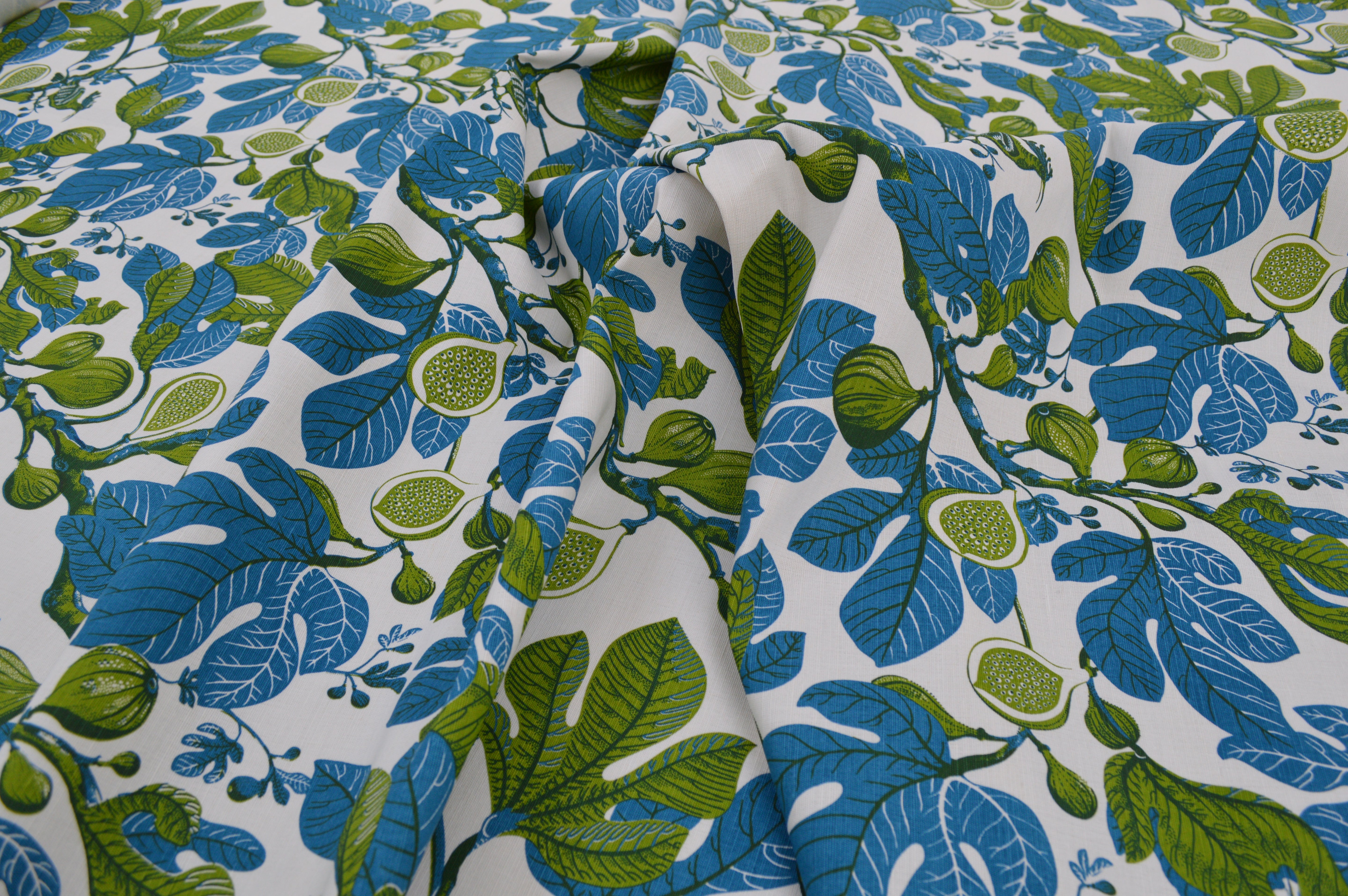 Fabric with blue and green leaf pattern on a white background