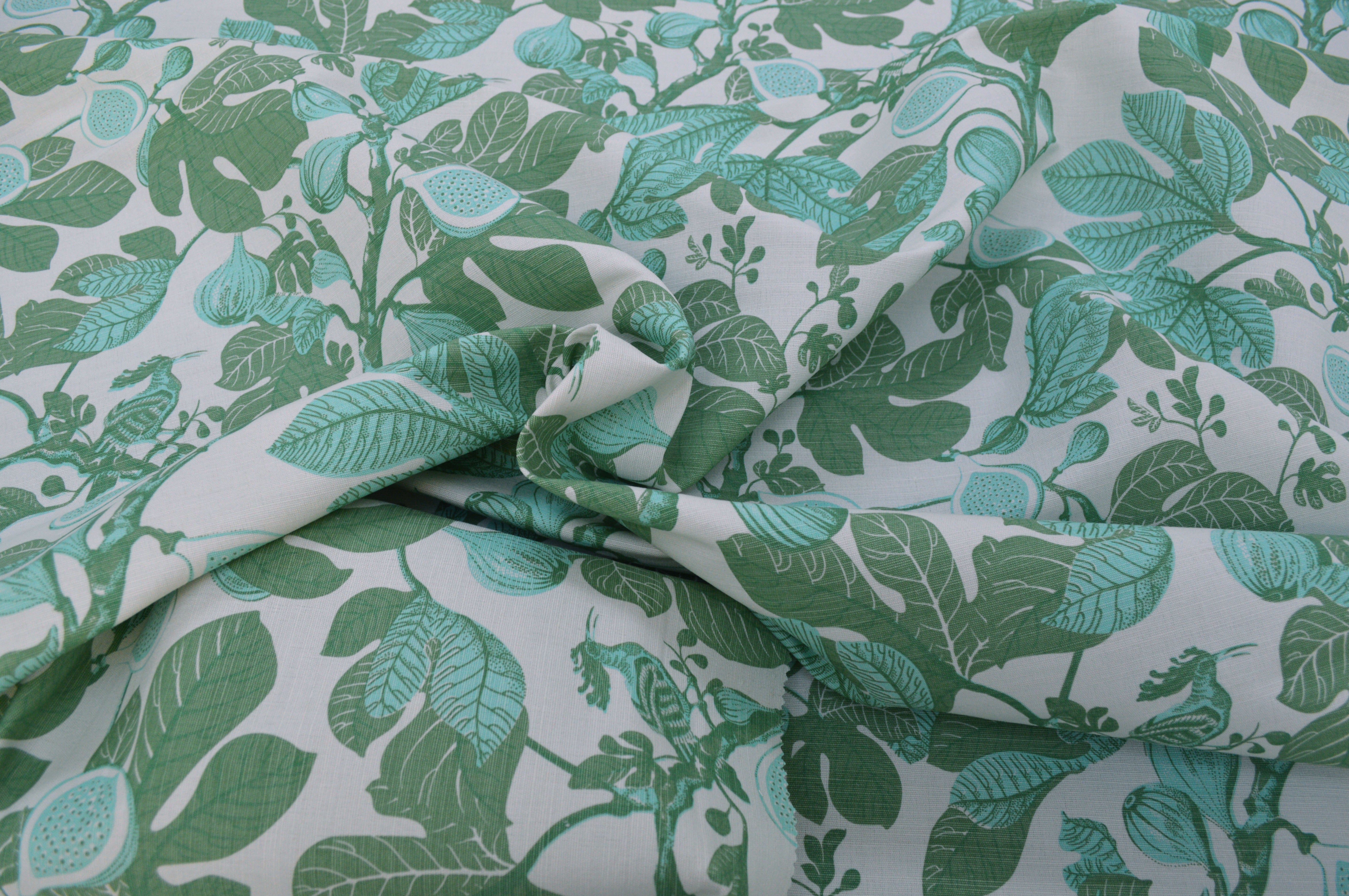 Fabric with green leaf pattern on a white background