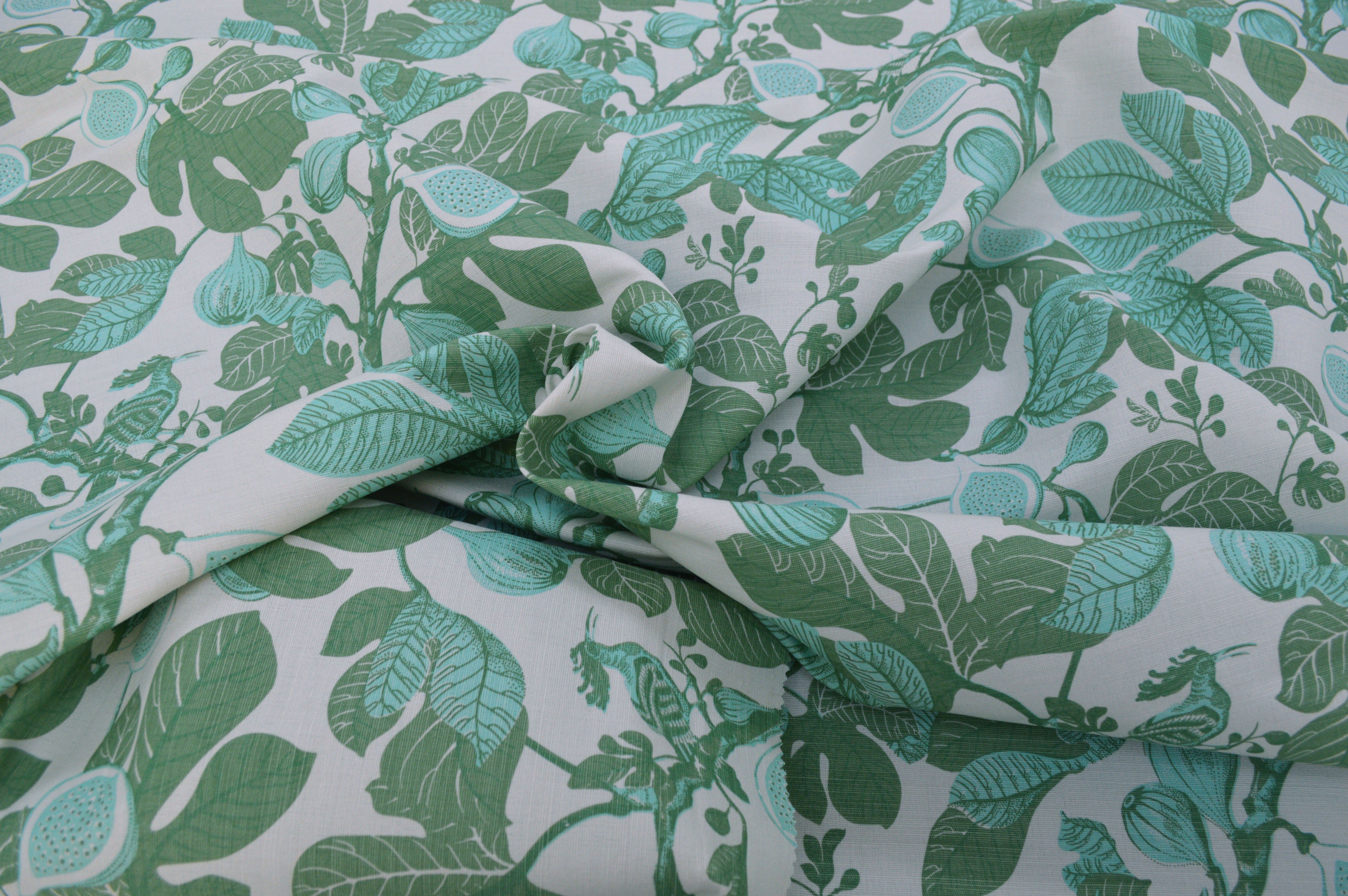 Fabric with green leaf pattern on a white background