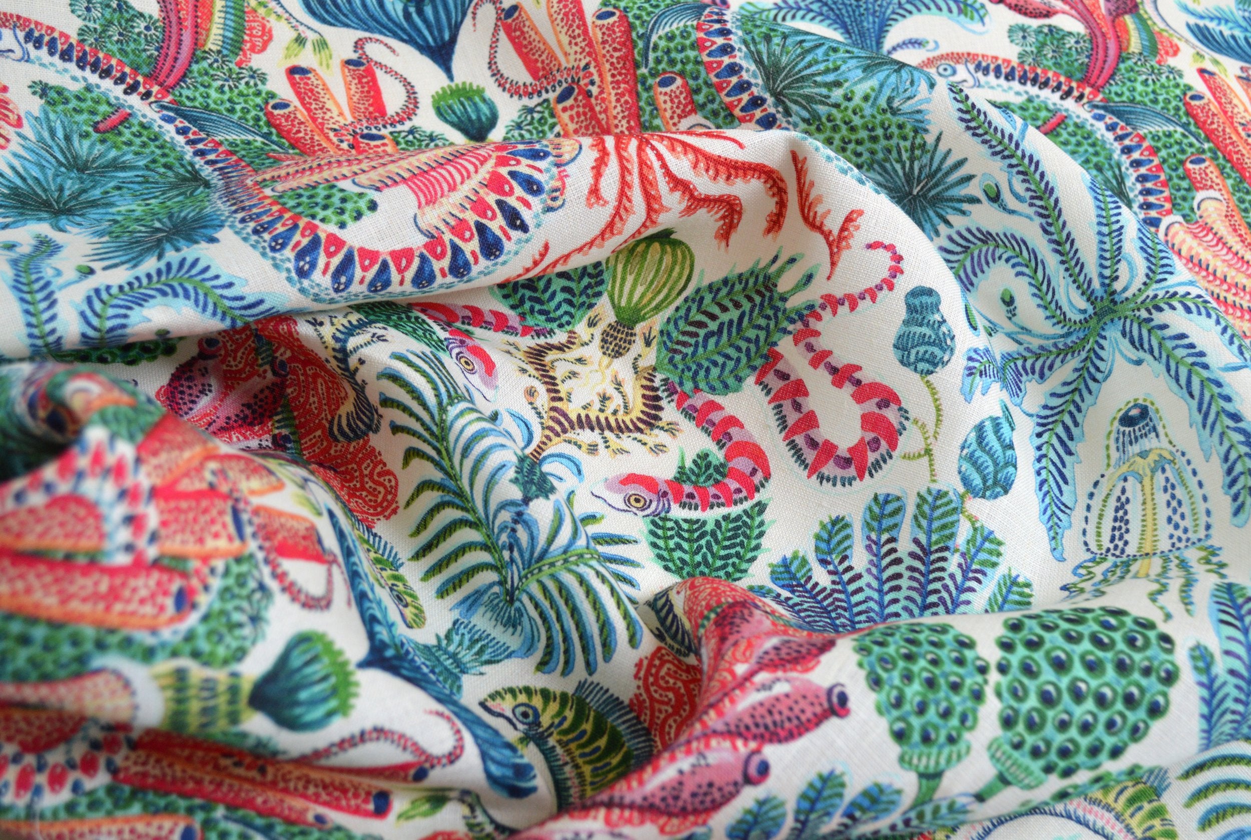 Colorful fabric with ocean-themed pattern featuring animals and plants.