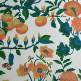 Green and orange floral and fruit pattern on a white background