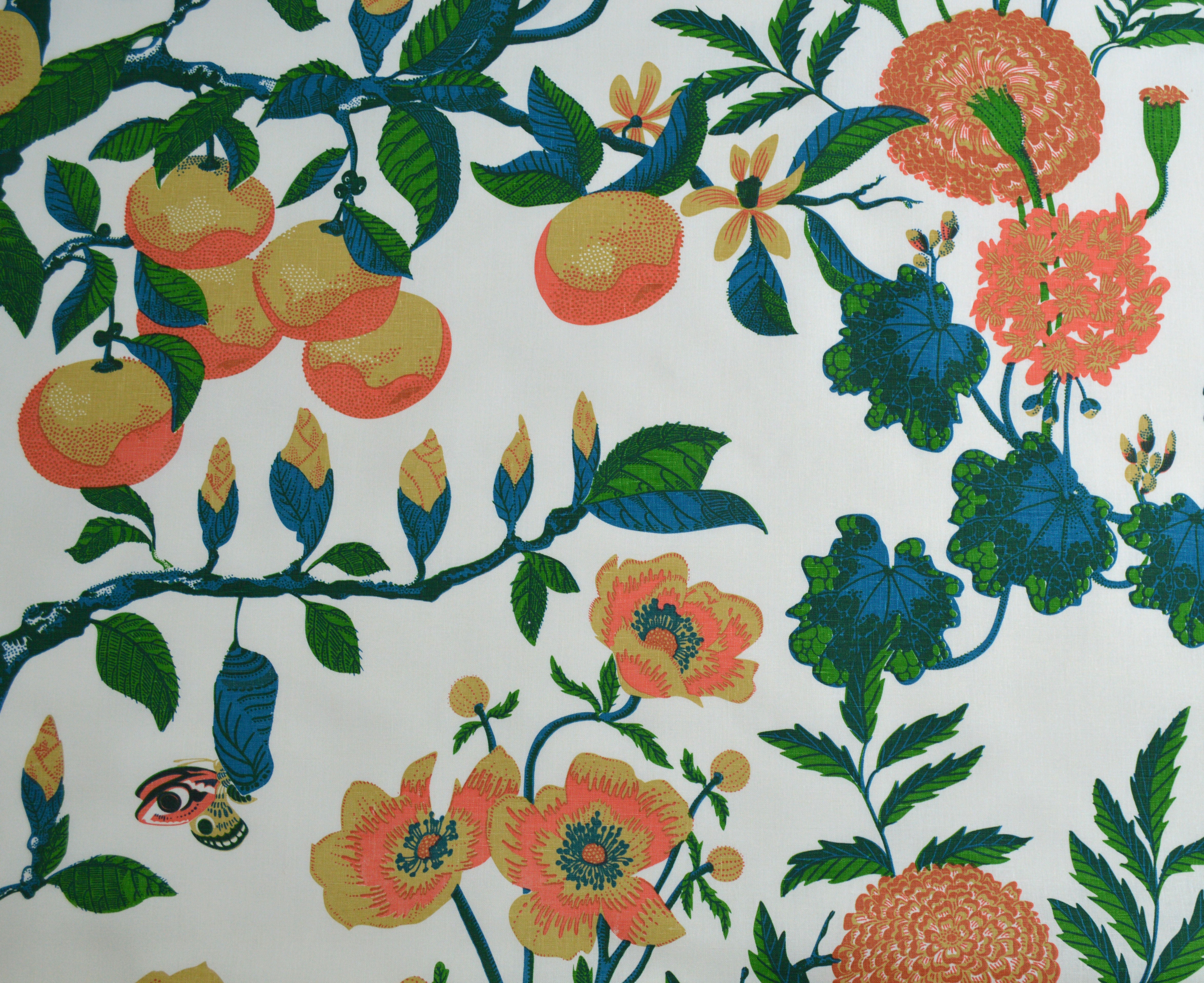 Green and orange floral and fruit pattern on a white background