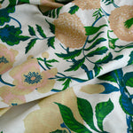 Floral fabric with green leaves and pink flowers on a white background