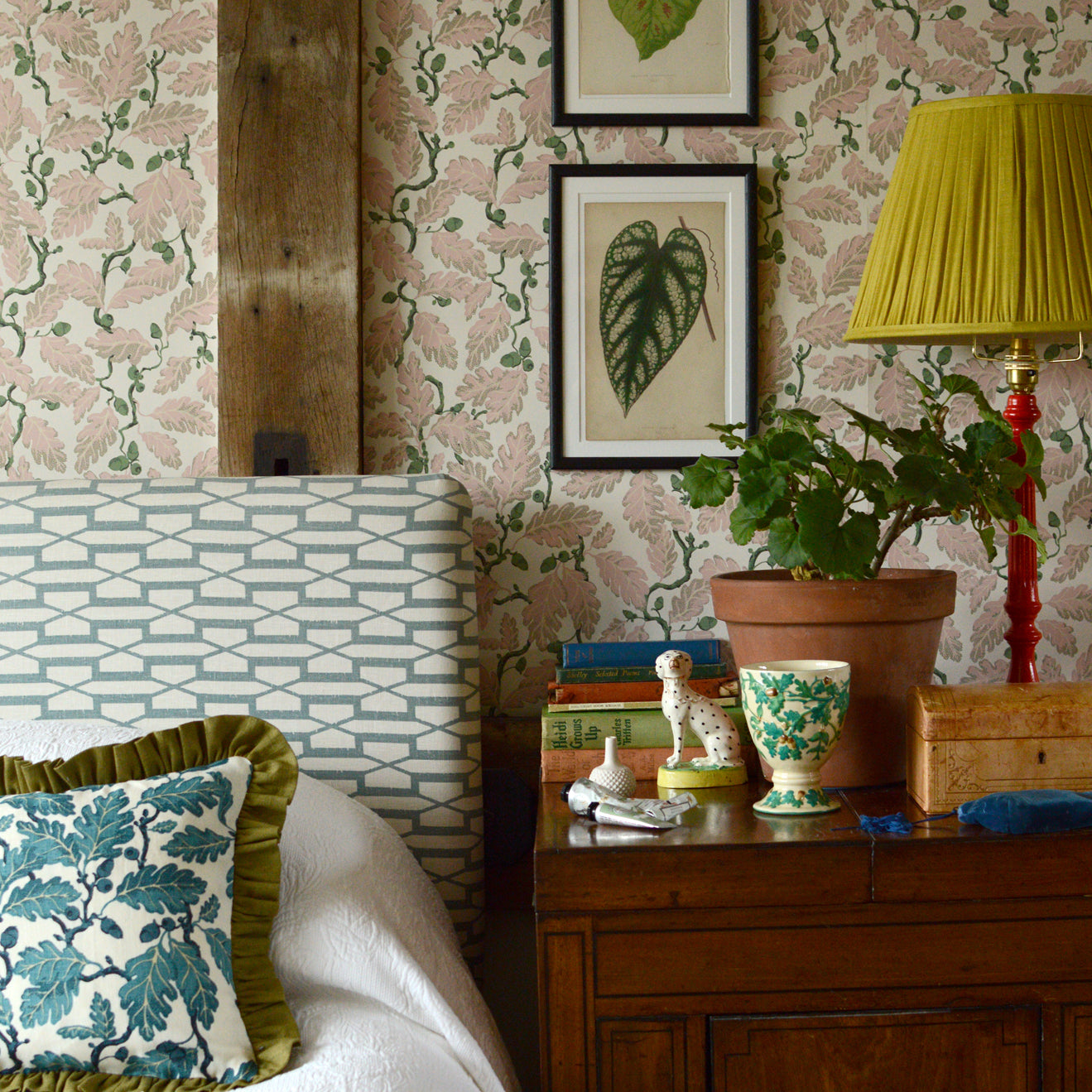 Decorative bedroom with floral wallpaper, a bed, and a wooden nightstand.