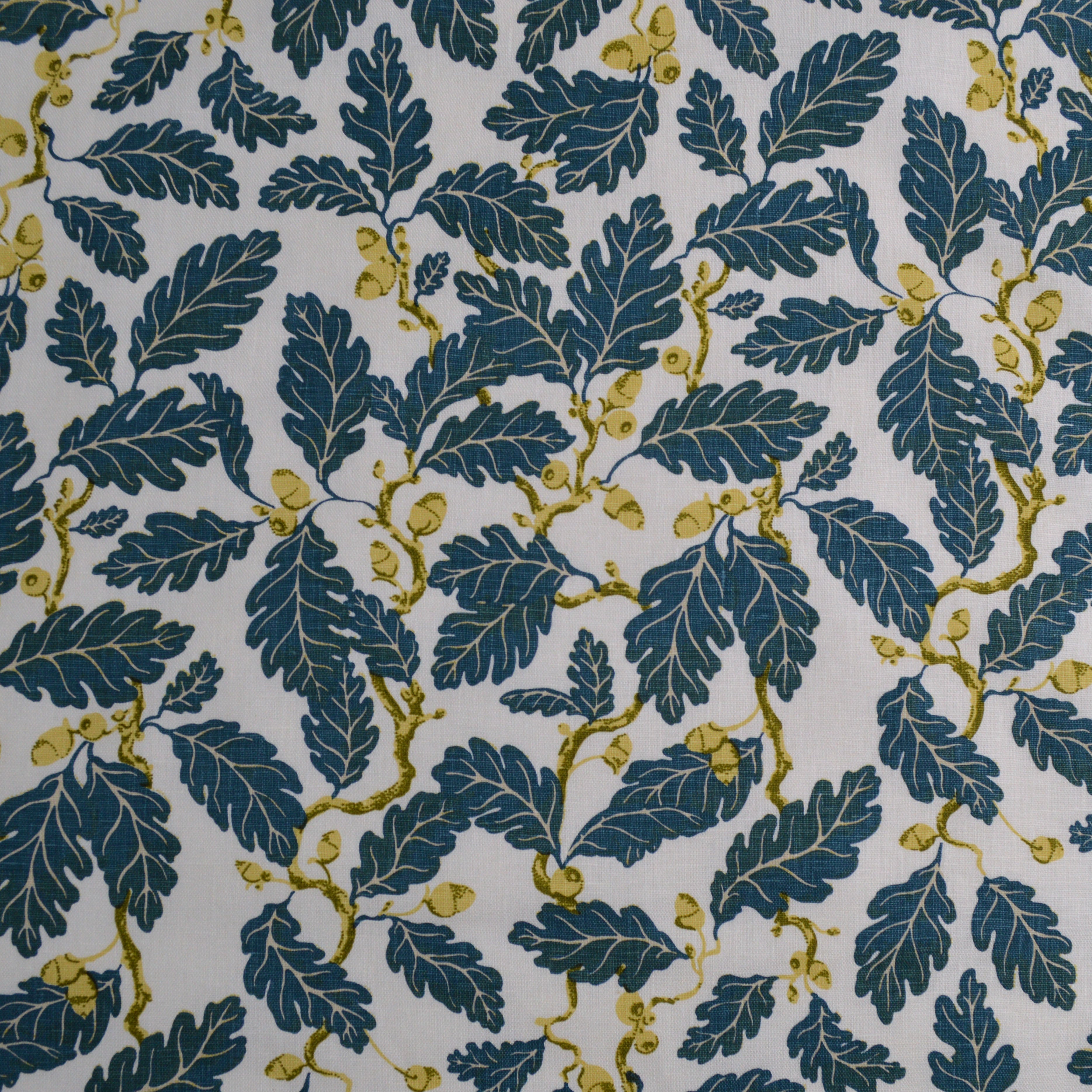 Pattern of blue leaves with yellow acorns and stems on a white background