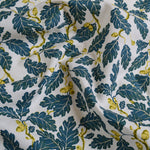 Fabric with blue leaf and yellow acorn pattern on a white background