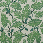 Patterned fabric with  green leaves and green acorns on a light background