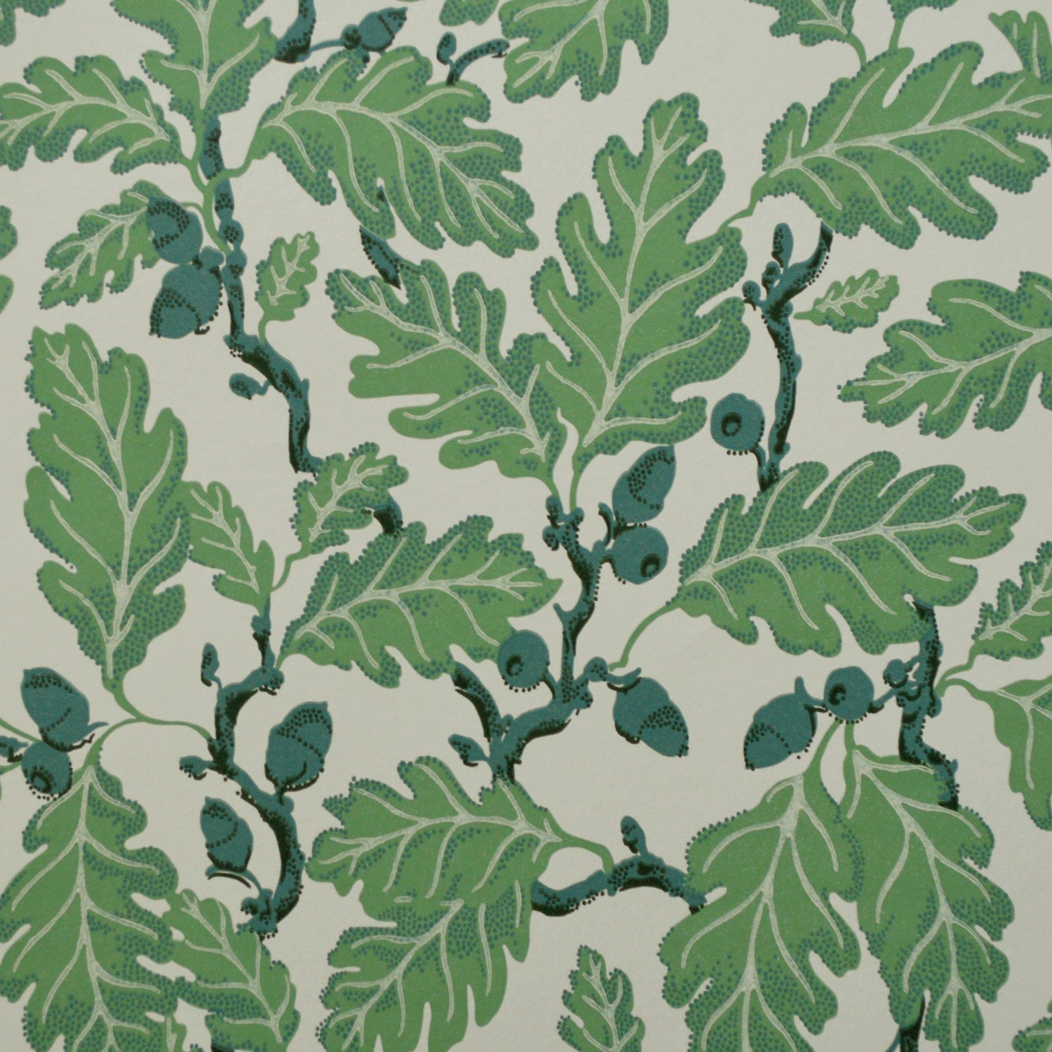 Patterned fabric with  green leaves and green acorns on a light background