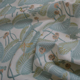 Floral fabric with green leaves and pink flowers on a white background