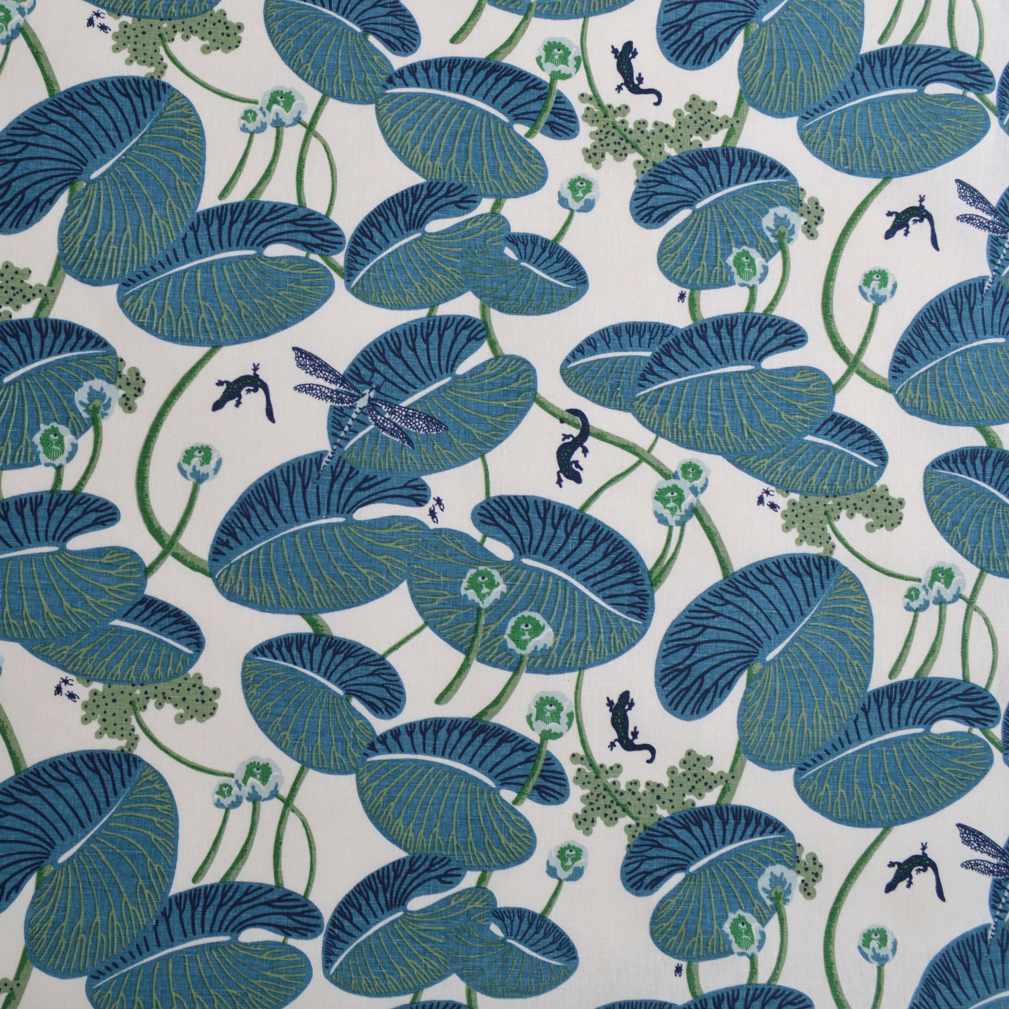 Pattern of blue lily pads and small creatures on a white background