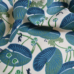 Fabric with blue and green lily pad pattern on a white background