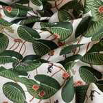 Fabric with green leaf pattern on a white background