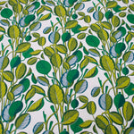 Patterned fabric with green and blue leaf design on a white background