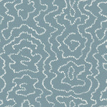 Detail of wallpaper in a minimalist wood grain print in white on a blue-gray field.