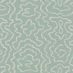 Detail of wallpaper in a minimalist wood grain print in cream on a light turquoise field.