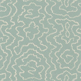 Detail of wallpaper in a minimalist wood grain print in cream on a light turquoise field.