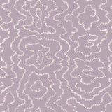 Detail of wallpaper in a minimalist wood grain print in white on a purple field.