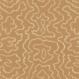 Detail of wallpaper in a minimalist wood grain print in cream on a tan field.