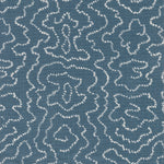 Detail of fabric in a minimalist wood grain print in cream on a navy field.