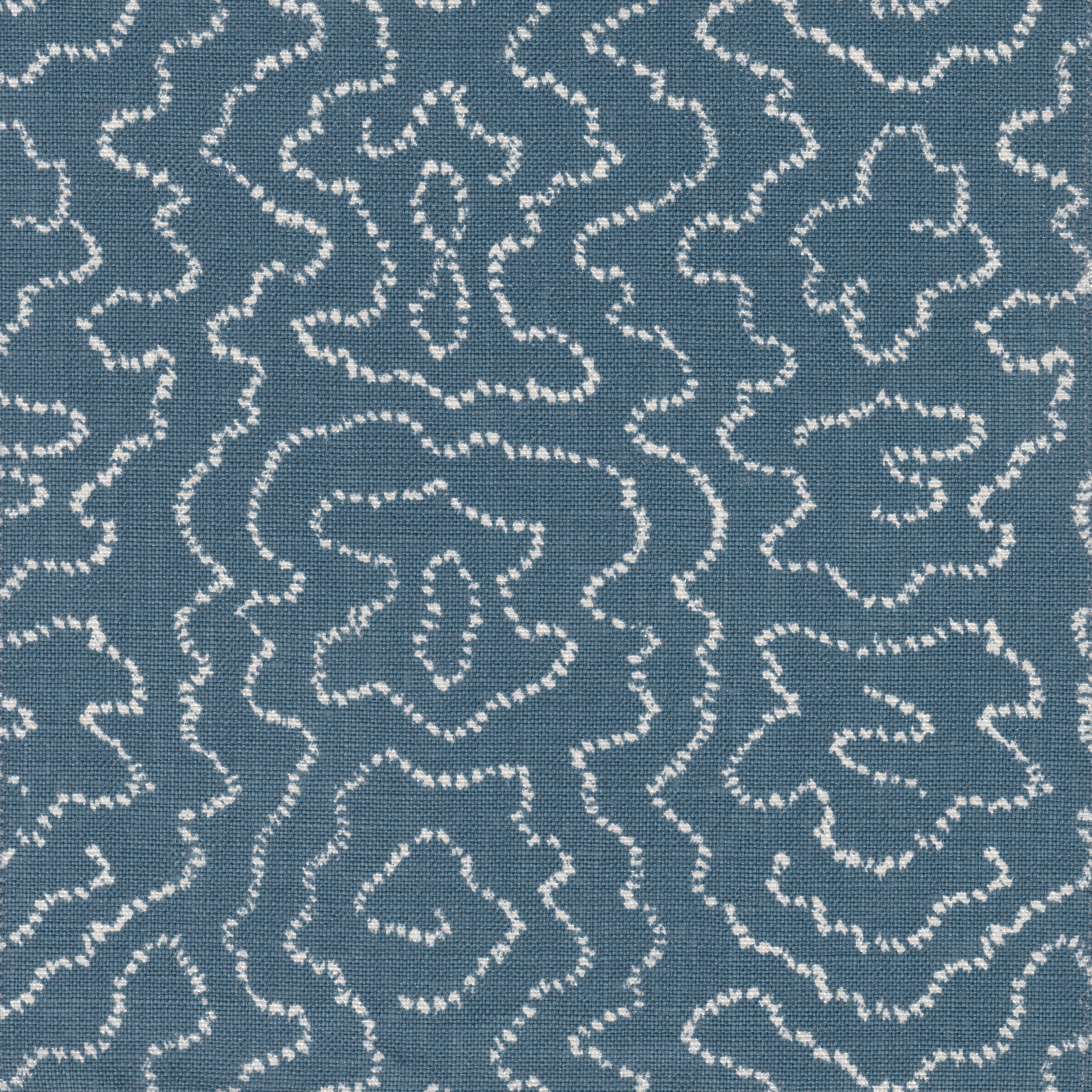 Detail of fabric in a minimalist wood grain print in cream on a navy field.