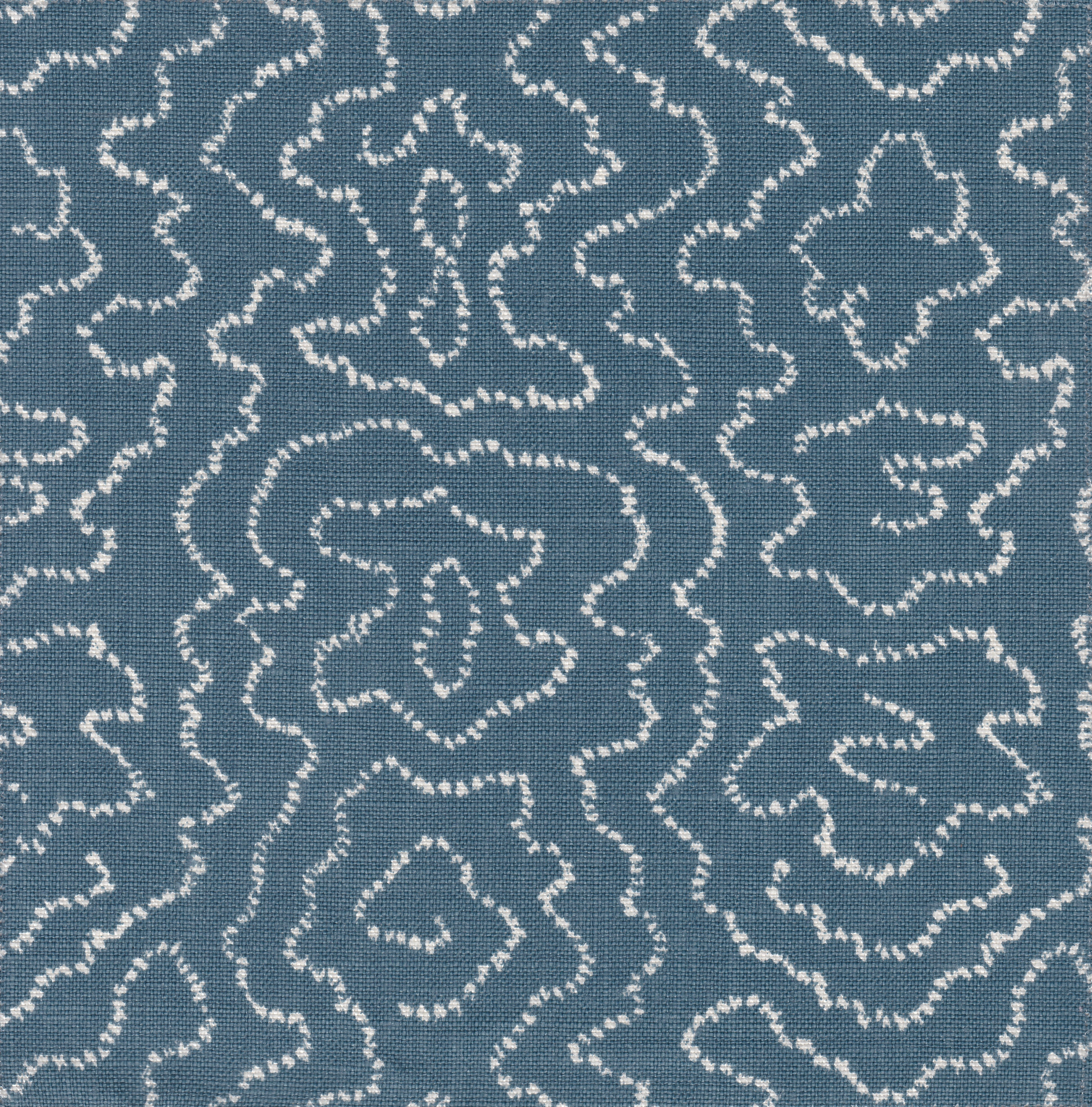 Detail of fabric in a minimalist wood grain print in cream on a navy field.