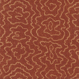 Detail of fabric in a minimalist wood grain print in tan on a rust field.