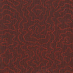 Detail of fabric in a minimalist wood grain print in red on a plum field.