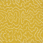 Detail of fabric in a minimalist wood grain print in white on a mustard field.