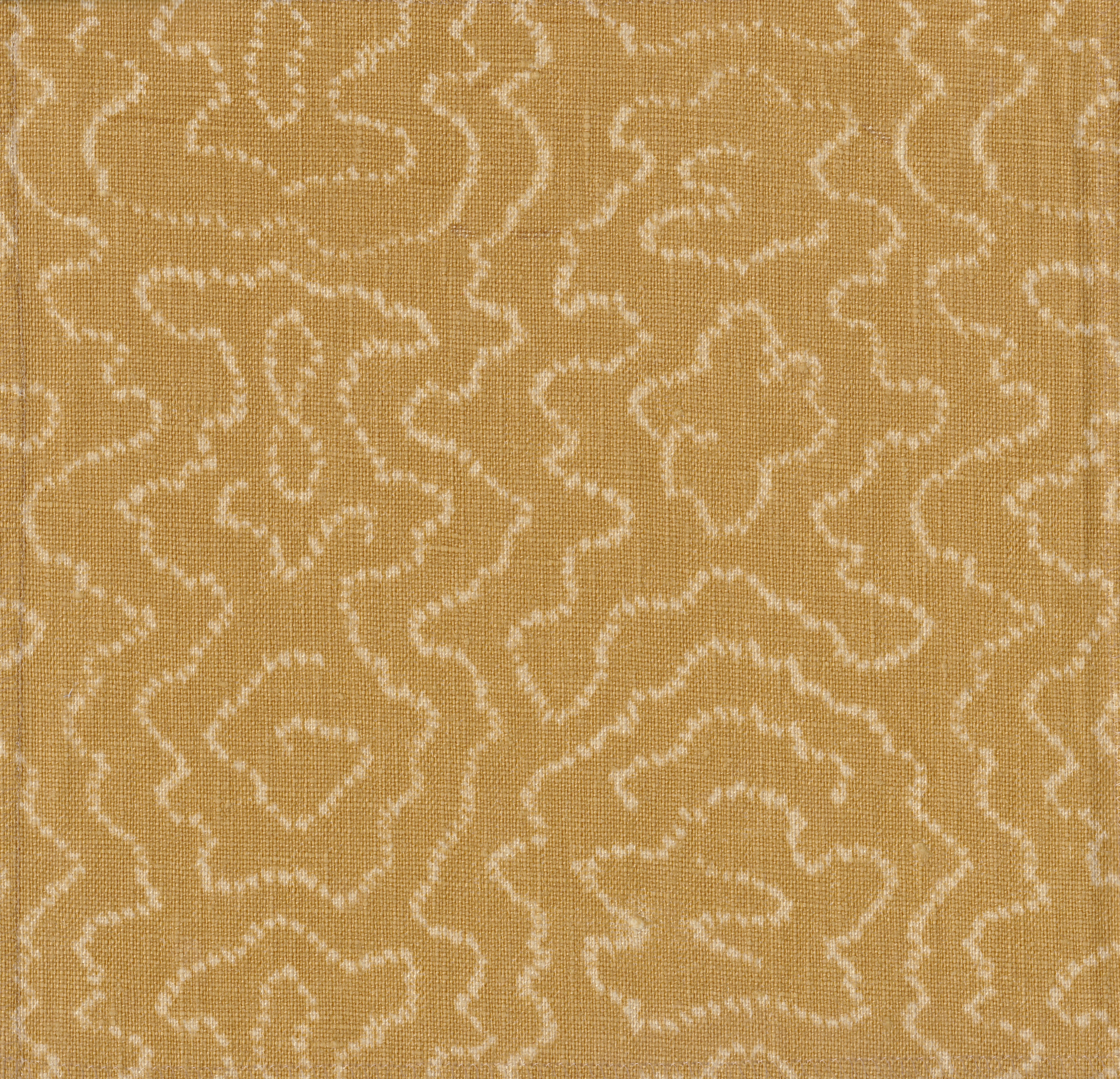 Detail of fabric in a minimalist wood grain print in cream on a tan field.