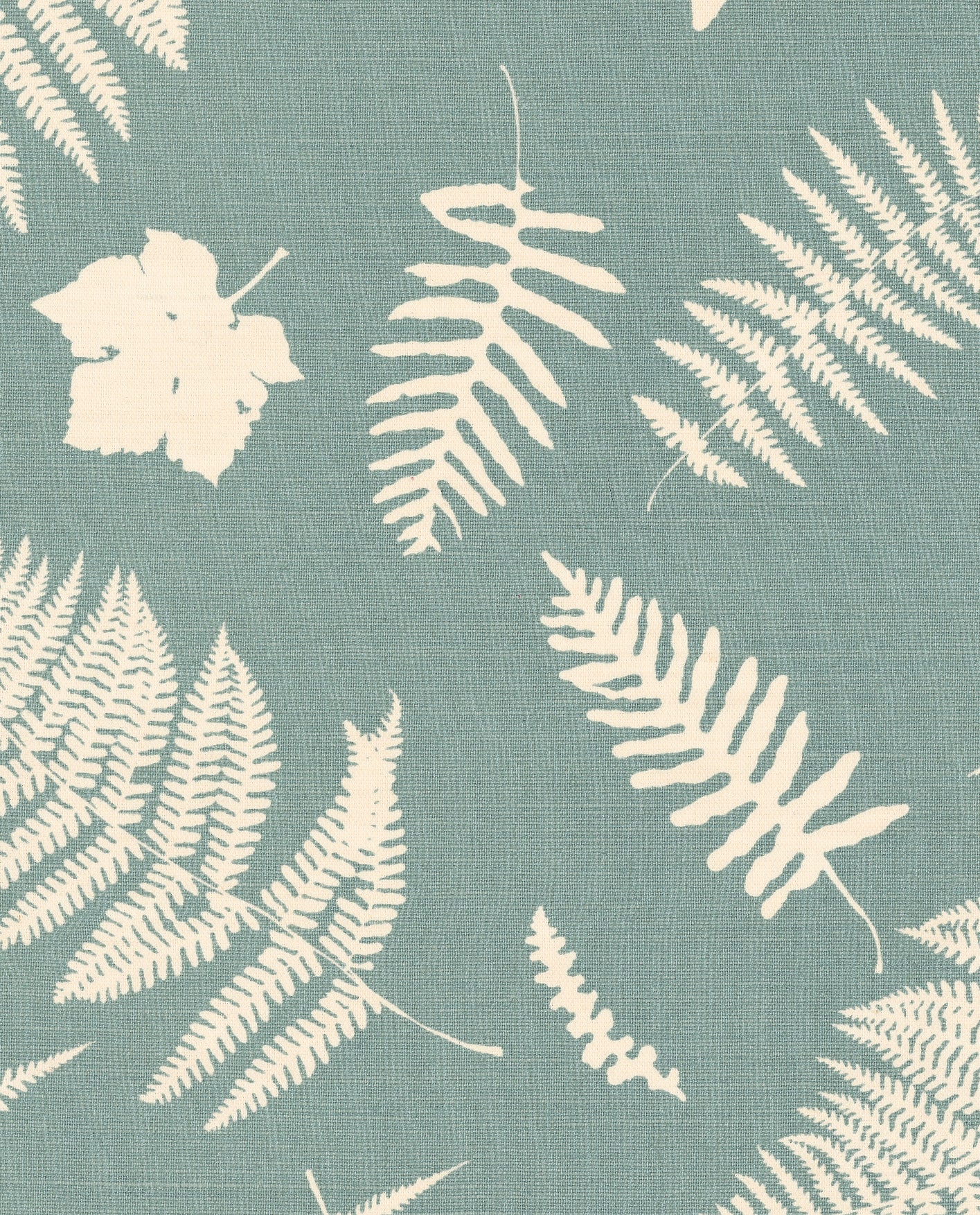 Detail of fabric in a repeating fern and dragonfly print in cream on a turquoise field.