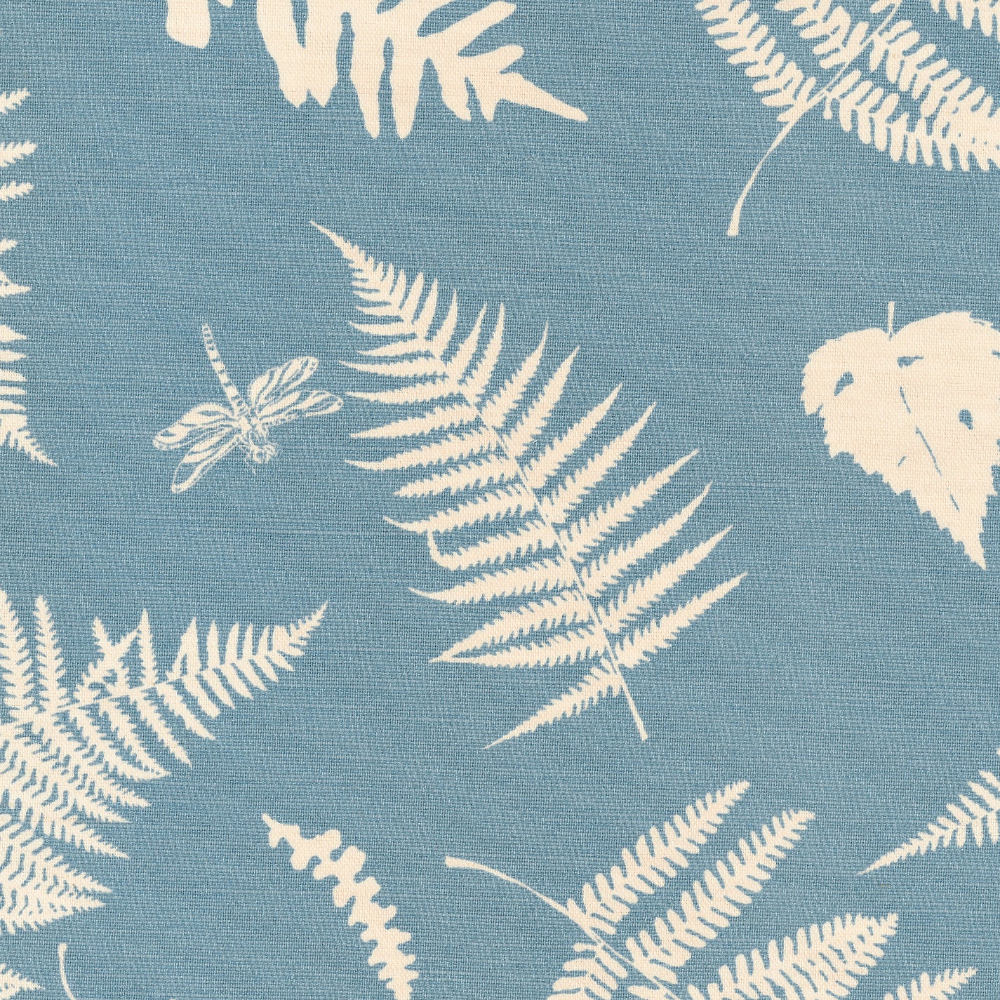 Detail of fabric in a repeating fern and dragonfly print in cream on a blue field.